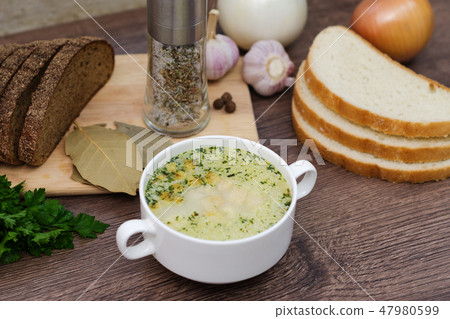 Mushroom soup with croutons in a white dish. Mushroom soup with croutons in a white dish. 47980599