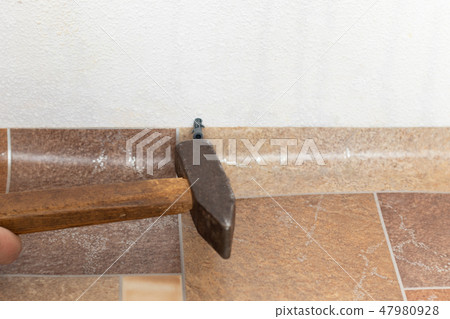 Installation of plastic floor plinth. Installation of plastic floor plinth. 47980928