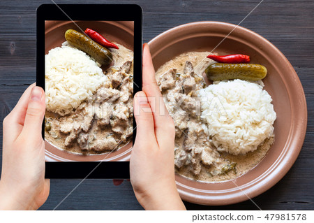 portion of Beef Stroganoff on dark table 47981578