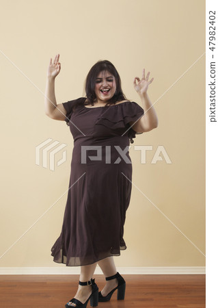 Fat woman dancing on high heels 47982402