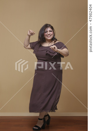 Fat woman dancing on high heels 47982404