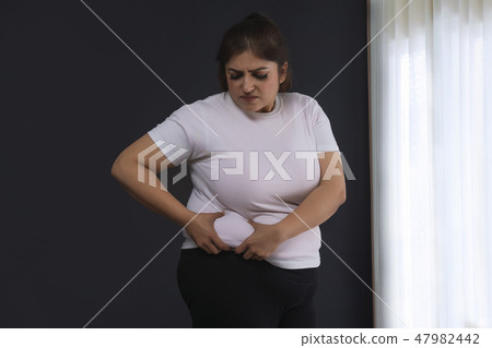 Woman Holding His Belly Fat With Both Hands Woman Holding His Belly Fat With Both Hands 47982442