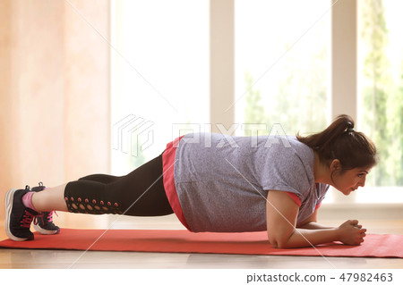 Overweight Woman Exercising 47982463