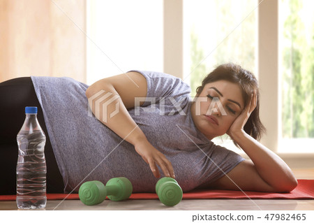 woman lying down on the floor 47982465