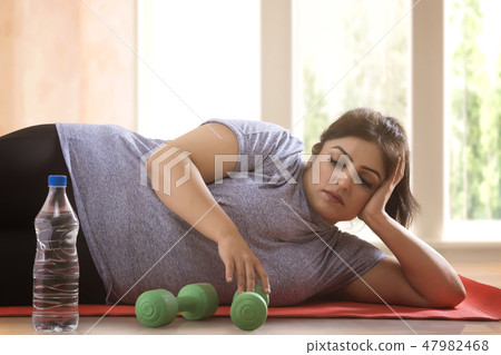 woman lying down on the floor woman lying down on the floor 47982468