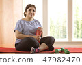 Overweight woman taking a break from exercising 47982470