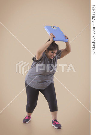 Woman Frustrated From Her Weight Throwing Scale 47982472