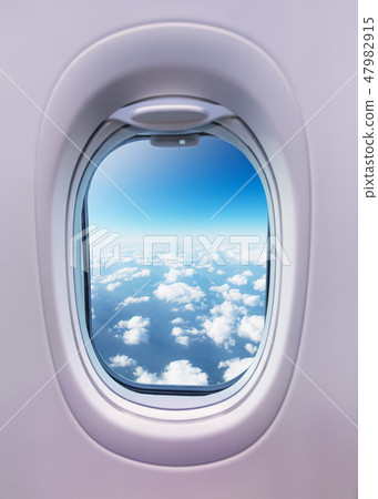 Airplane interior with window view of clouds. 47982915