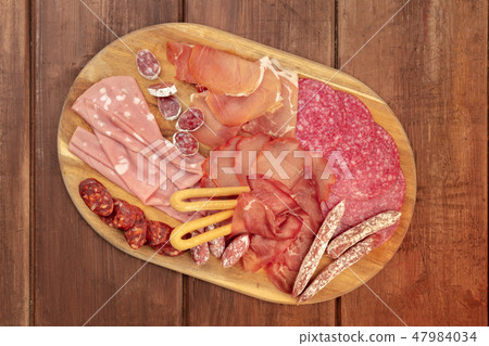 Charcuterie Tasting. A platter with various sausages and hams, cold cuts, shot from the top on a Charcuterie Tasting. A platter with various sausages and hams, cold cuts, shot from the top on a 47984034