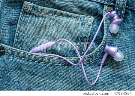 Earphones stick out of jeans pocket Earphones stick out of jeans pocket 47984594