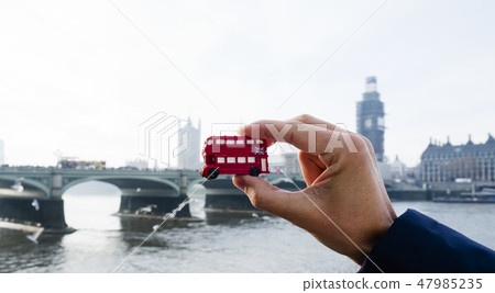 man with a londoner red double-decker bus 47985235