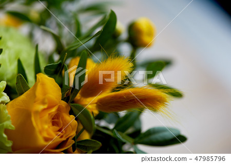 Yellow bouquet with green carnation, in the composition of chrysanthemums, roses and dyed grains 47985796