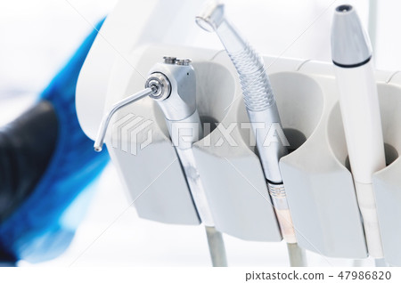 Close-up set of professional tools in the dentist's office on the holder. High key. Stamotology 47986820