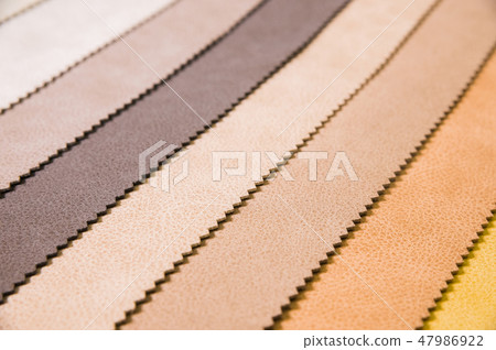 Colorful and bright fabric samples of leatherette furniture and clothing upholstery. Close-up of a Colorful and bright fabric samples of leatherette furniture and clothing upholstery. Close-up of a 47986922