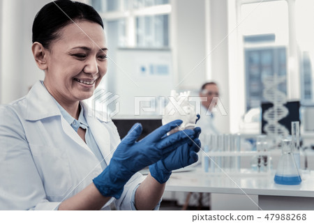 Smiling scientist working with the plastic model Smiling scientist working with the plastic model 47988268