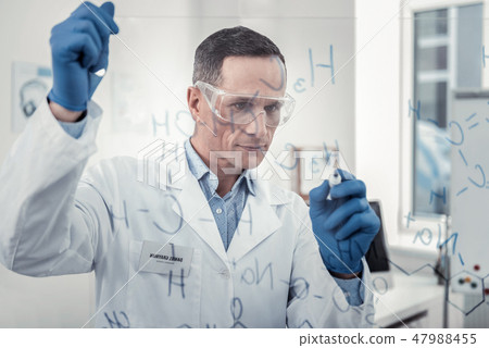 Scientist working out the formula of new material Scientist working out the formula of new material 47988455