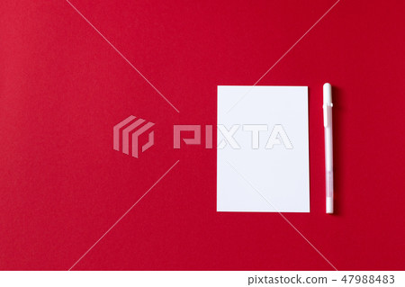 Empty white paper sheet isolated on red background Empty white paper sheet isolated on red background 47988483