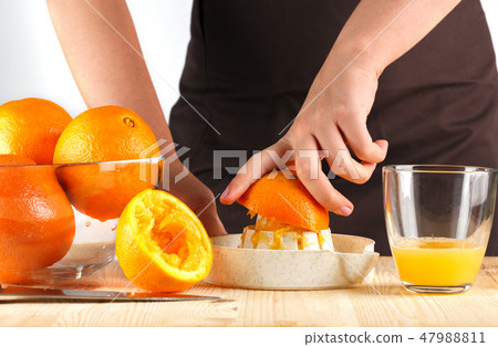 girl preparing fresh citrus juice girl preparing fresh citrus juice 47988811