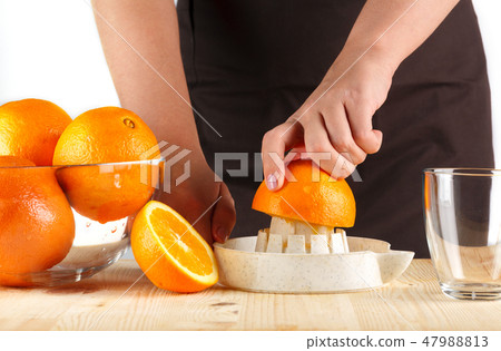 girl preparing fresh citrus juice girl preparing fresh citrus juice 47988813