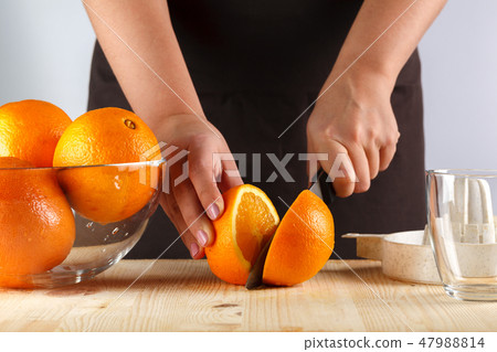 girl preparing fresh citrus juice girl preparing fresh citrus juice 47988814