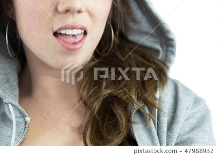Young teen girl with tongue piercing and hoodie 47988932