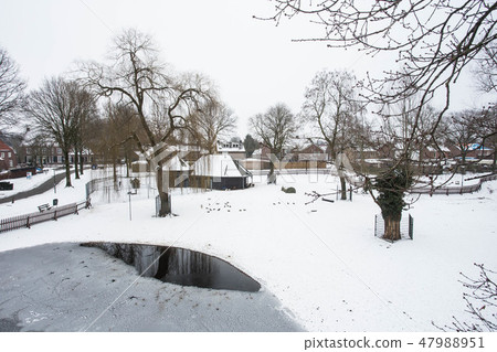 Aerial view of snow covered traditional housing in the Netherlands. 47988951
