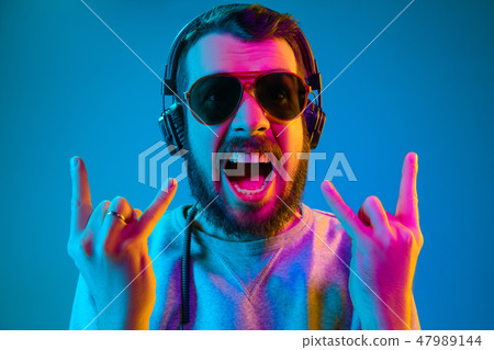 Enjoying his favorite music. 47989144