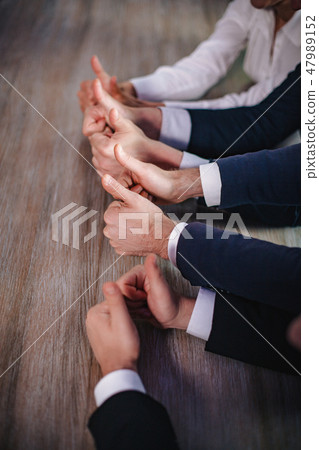 Businessmen holding big thumbs up. Close up. Businessmen holding big thumbs up. Close up. 47989152