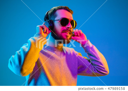 Enjoying his favorite music. Enjoying his favorite music. 47989158