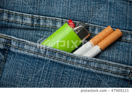 cigarettes ans lighter in blue jeans pocket cigarettes ans lighter in blue jeans pocket 47989221