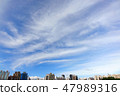 Modern city building and large fluffy clouds 47989316