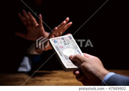 Businessman refusing money offered by his partner 47989902