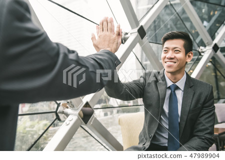 Asian businessman giving high five to his partner 47989904