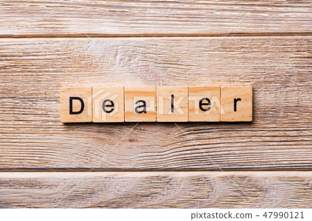 Dealer word written on wood block. Dealer word written on wood block. 47990121