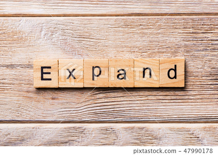 EXPAND word written on wood block. EXPAND word written on wood block. 47990178