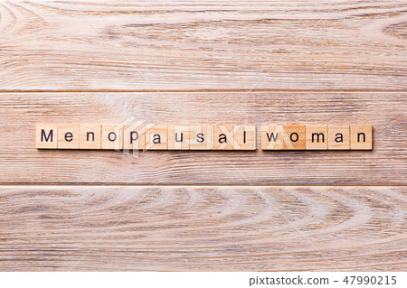 menopausal woman word written on wood block. menopausal woman word written on wood block. 47990215