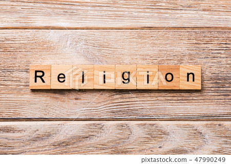Religion word written on wood block.  47990249