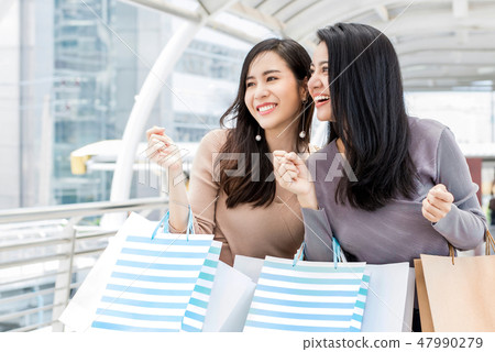 Happy young Asian women friends enjoying shopping  47990279