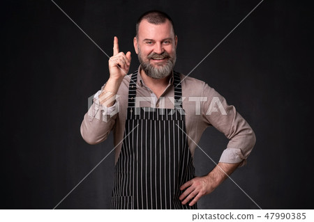Cook provides advice and recommendation, pointing his index finger upwards Cook provides advice and recommendation, pointing his index finger upwards 47990385