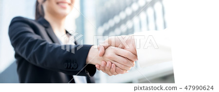 businesswomen having a firm handshake with client 47990624