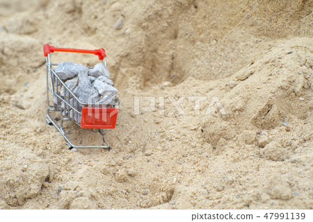 Shopping trolley stand on the pile of sand Shopping trolley stand on the pile of sand 47991139