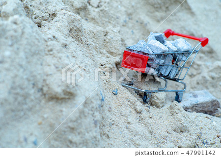 Shopping trolley stand on the pile of sand Shopping trolley stand on the pile of sand 47991142