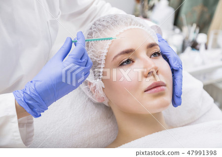 Young woman patient receiving surgery injection Young woman patient receiving surgery injection 47991398