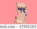 female hands with blue glossy manicure 47992163