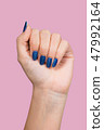female hand with blue glossy professional manicure 47992164