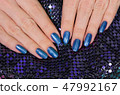 hands with blue glossy professional manicure 47992167