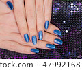 hands with blue glossy professional manicure 47992168