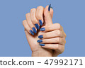 hands with blue glossy professional manicure 47992171