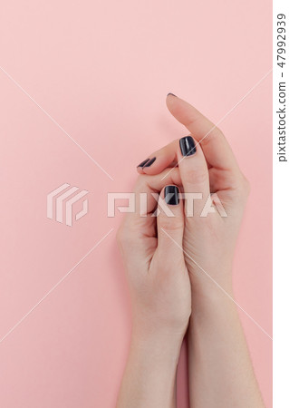 Woman's hands with black manicure 47992939