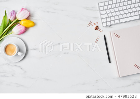 Office desk with computer and tulip flowers Office desk with computer and tulip flowers 47993528
